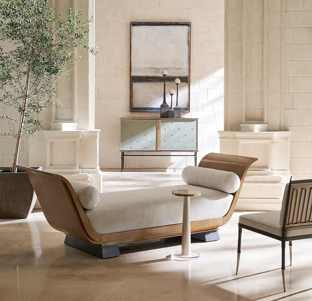 A simplified Roman Chaise Lounge sits in a marble room with classical details.